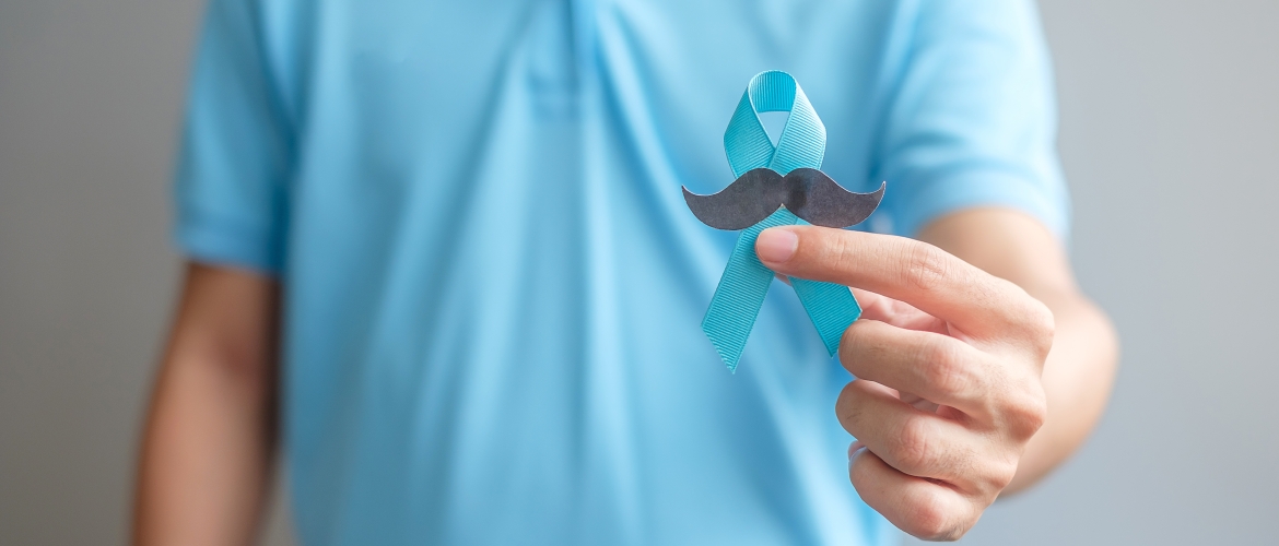 Movember - November Prostate Cancer Awareness month, Man holding Blue Ribbon